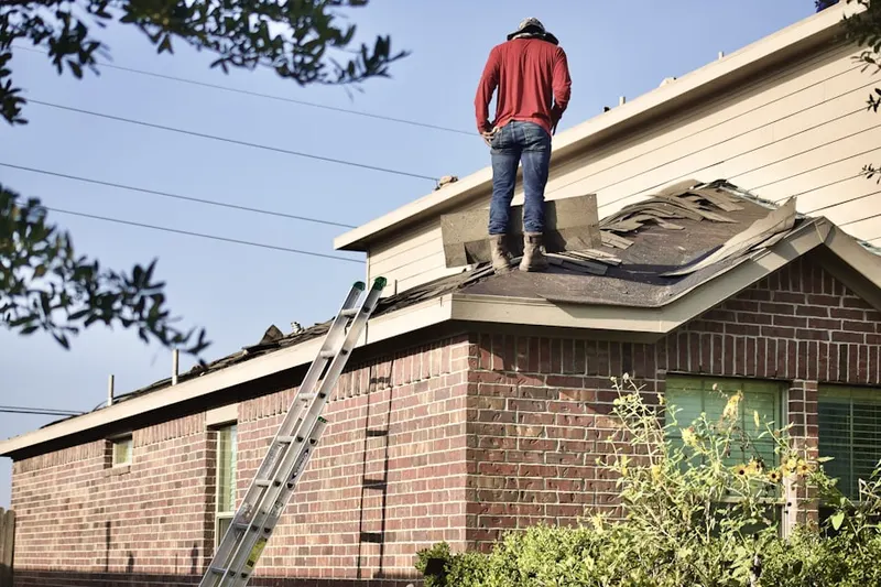 Professional roofer working on a residential roof in Charlton Estates